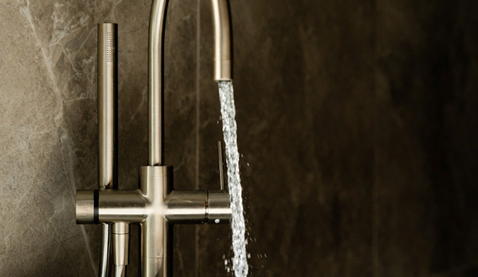 Filtered water running from a bath tap in a sustainable home